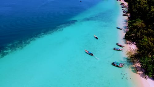 Koh Kradan Island Southern Thailand with Longtail Boats at the Beach and a Turqouse Colored Ocean