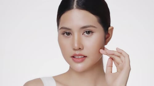 Woman Posing with Dewy Skin in Studio