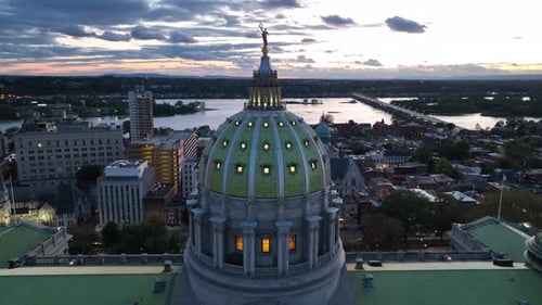 Pennsylvania capitol building dome at night. Aerial orbit around lit up government building in Harri