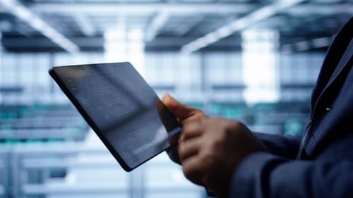 IT Specialist Working in Data Center Facility Housing Storage Hardware Close Up