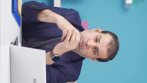 Adult massing hand and head near computer