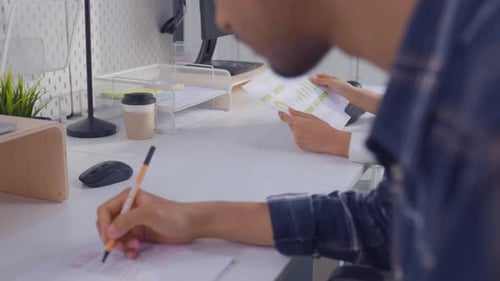Young attractive businessman and businesswoman work in office workplace.