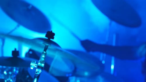 Professional Drummer Playing on the Drum By Wooden Sticks During Rock Concert