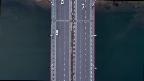 Above View of Cars Driving Along Road and Water in Countryside Outdoors Irrl