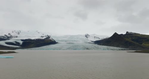 aerial view of Fjallsjökull glacier over lagoon in iceland