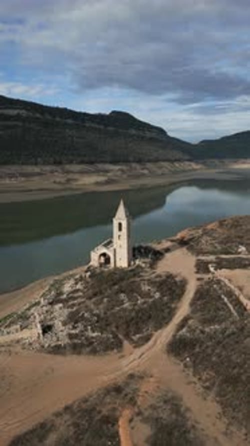 Vertical Drone Shot of Church Sau Swamp Dike in Catalonia Spain Drought in 2024 Pantano De Sau