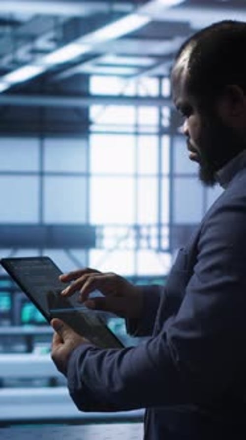 Vertical Video System Administrator in Server Room Installing Newly Ordered Storage Unit