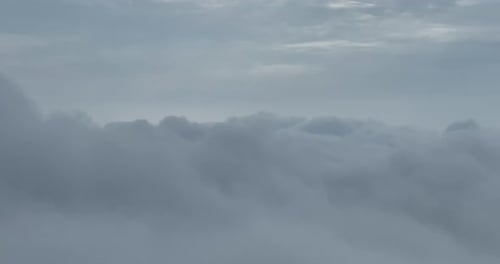 Fluffy Clouds Drifting Under a Gray Sky