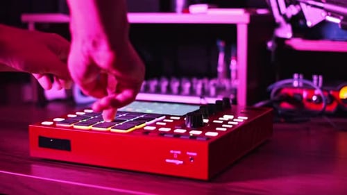 Musician Creating Beats on Beatmaker in Music Studio