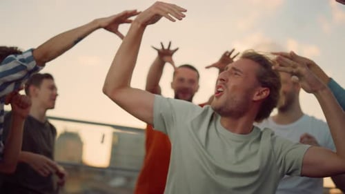 Excited People Cheering at Rooftop Party