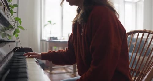 Close Up of Brunette Girl Playing Piano and Slowly Moving Her Fingers at Home Learning to Play
