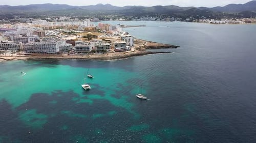 Aerial drone footage of the town of Sant Antoni de Portmany on the west coast of Ibiza Spain