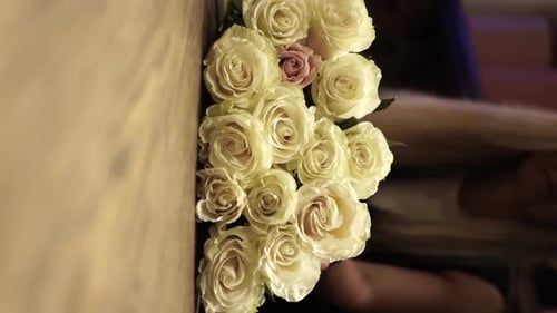 female florist makes beautiful bouquet in flower shop