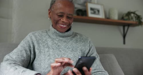 Happy Woman Using Cell Phone at Home