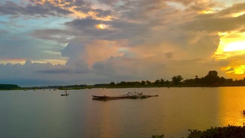 The beautiful sunset over the calm waters of the lake makes for a perfect view