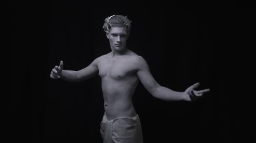 Living Statue of the Ancient Man Poses Black Background