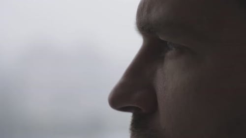 Thoughtful Young Man Posing on White Background Side View Slow Motion