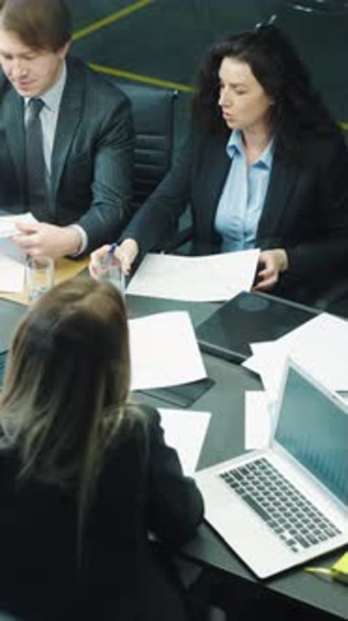 Business Meeting at Conference Table in Modern Office