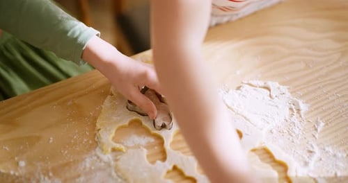 Child Cutting Cookie Dough with Cookie Cutter