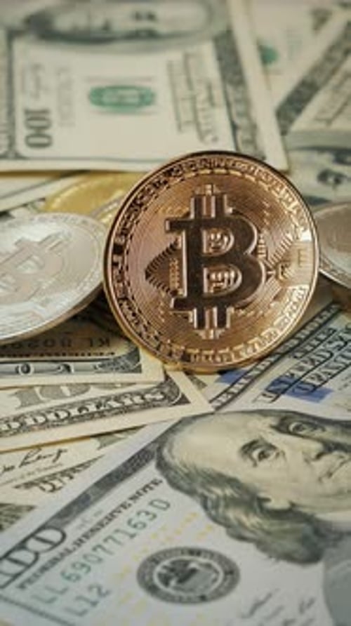 Bitcoin Coins Stacked on US Dollar Bills