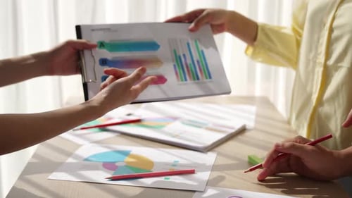 Startup company employee working together analyzing BI dashboard paper. Synergic