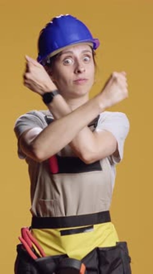 Vertical Video Portrait of Strong Handywoman Doing x Shape Sign with Arms Crossed