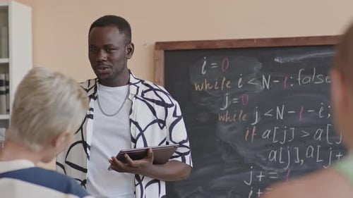 Engaging Teacher Explains Lesson in Classroom