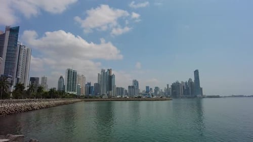 A cityscape of a bustling metropolis nestled by a serene river, The water flows calmly, reflecting