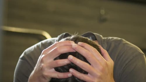 Depressed man indoors, dolly shot close up