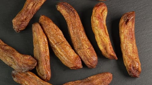 Close-Up of Dried Bananas on a Black Surface