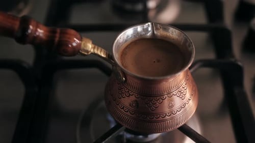 Close Up of Cezve with Aromatic Coffee is Prepared on the Stove Preparation of Turkish Coffee in