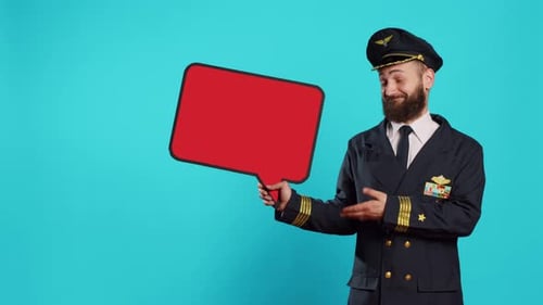 Male Flying Pilot Holding Red Blank Speech Bubble