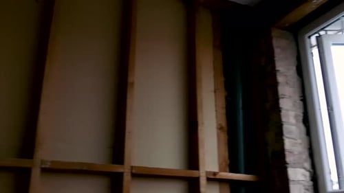 Interior Construction with Exposed Wall Framing and Window