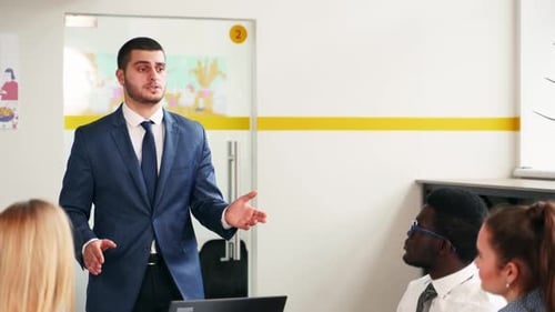 Business Presentation by Man in Suit to Colleagues