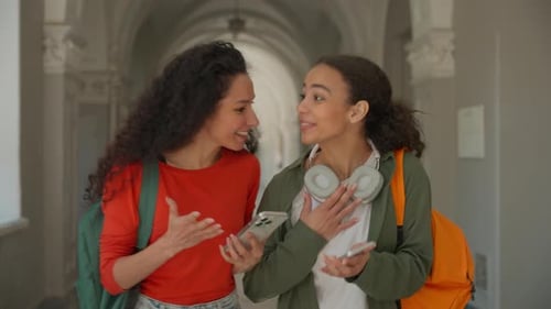 Two Friends Hispanic Ethnic Girls Latina Women Female Ladies Students Walking in Corridor University