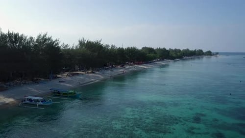 Morning drone shot of moored boats on Gili Trawangan coastline