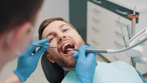 Man receiving dental work at the dentist office