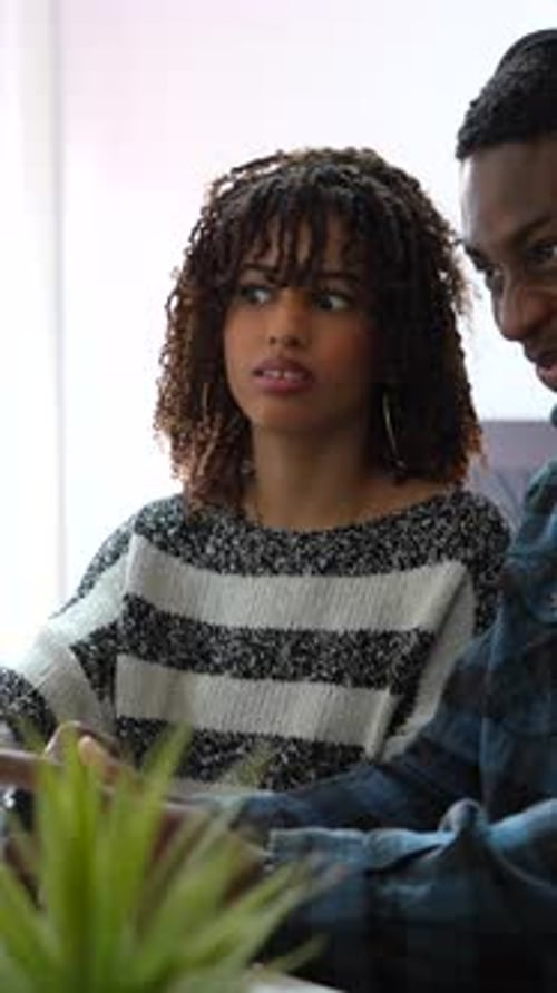 Young Woman and Man Indoors Using Computer
