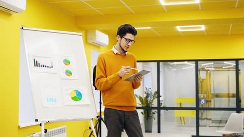 Businessman Coach Trainer Presents Report Shows Diagrams on Flip Chart in Conference Hall Project