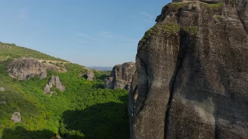 Soaring Over Vibrant Green Forests the Camera Captures a Remarkable Rock Formations Revealing a