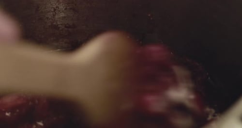 Red Fruit Simmering and Stirred in Cooking Pot