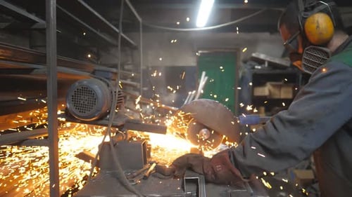 Worker in Safety Protection Wear Use Saw Cutting Machine to Cut Metal Man with Circular Saw Sawing