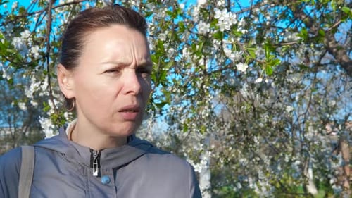 Woman Uses Inhaler Outdoors During Spring Allergy Season