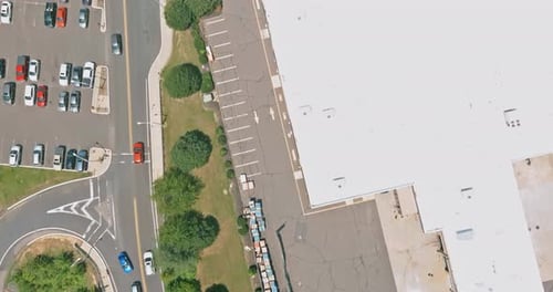View of Parking Area with Cars Large Building in Commercial Area