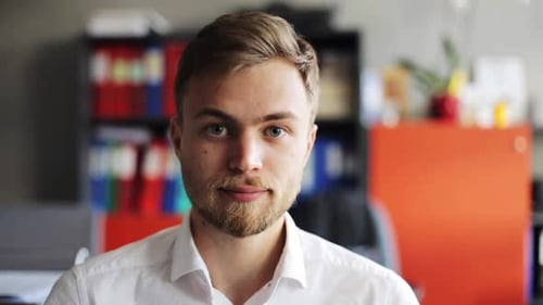 Smiling young businessman in office a portrait of joyful success