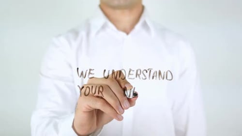 We Understand Your Needs Man Writing on Glass