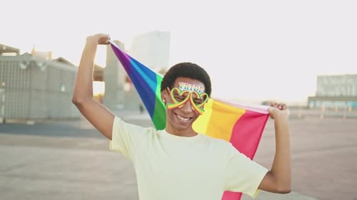 Young Adult Celebrating Pride With Rainbow Flag
