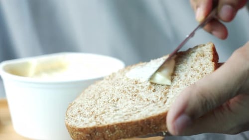 Spreading Butter on Wheat Bread Slice