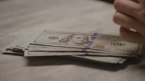 Counting Stack of United States Hundred Dollar Bills