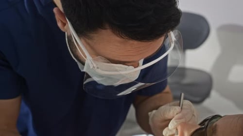Dentist Examining Patient Teeth Using Dental Tools on Treatment Chair